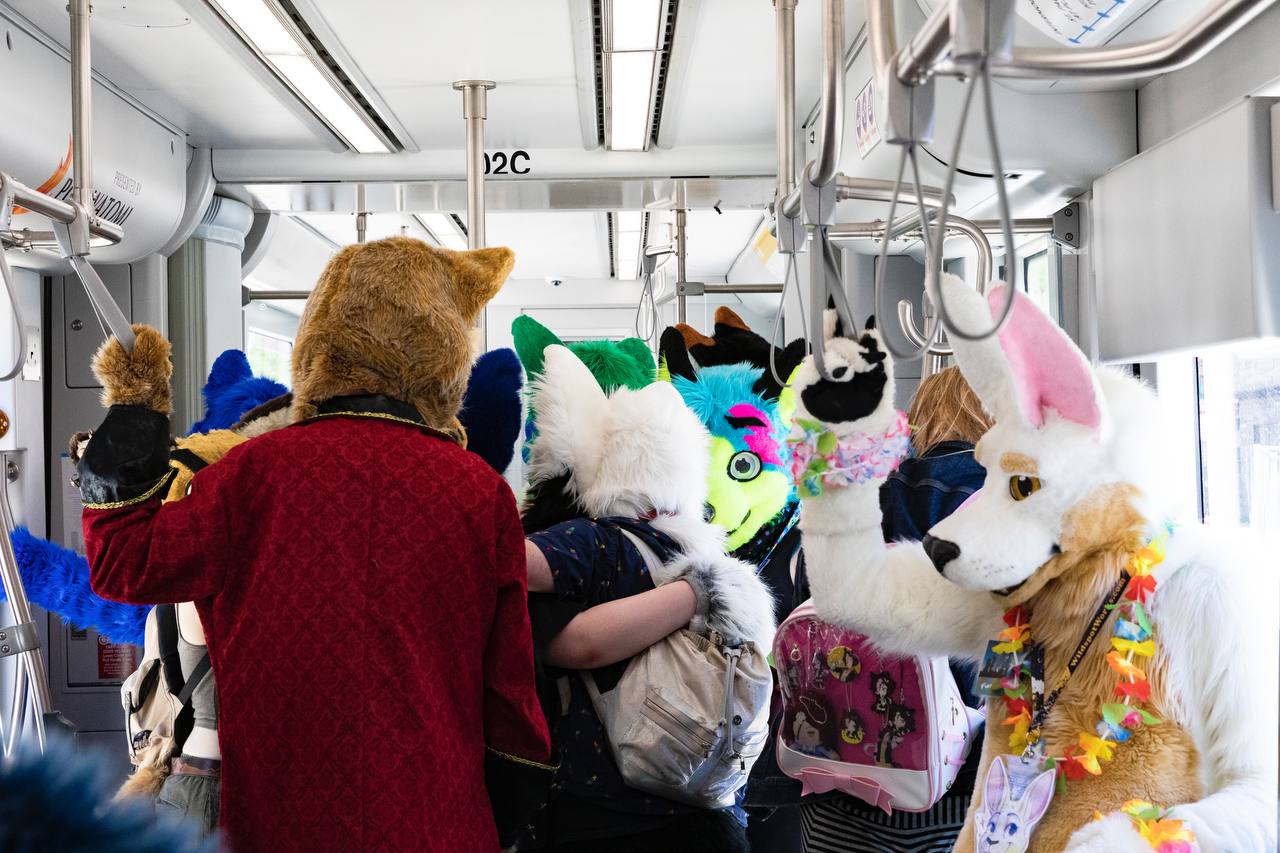 Lilia Roo in a streetcar with a bunch of other fursuiters during a Furmeet.